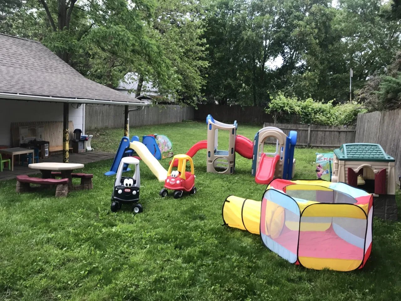 Backyard play area with slides and playhouses